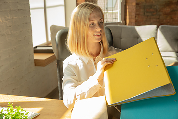 Image showing A young businesswoman moving in office, getting new work place