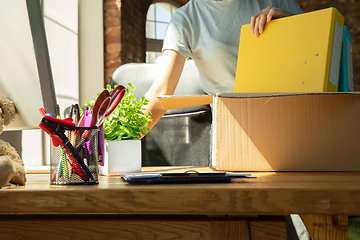Image showing A young businesswoman moving in office, getting new work place