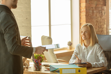 Image showing A young businesswoman moving in office, getting new work place