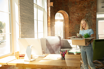 Image showing A young businesswoman moving in office, getting new work place