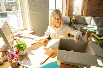 Image showing A young businesswoman moving in office, getting new work place