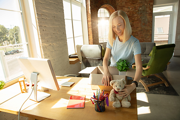 Image showing A young businesswoman moving in office, getting new work place