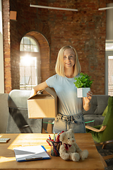 Image showing A young businesswoman moving in office, getting new work place