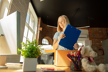 Image showing A young businesswoman moving in office, getting new work place