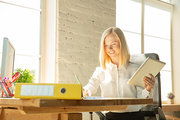 Image showing A young businesswoman moving in office, getting new work place