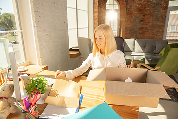 Image showing A young businesswoman moving in office, getting new work place