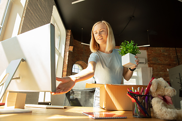 Image showing A young businesswoman moving in office, getting new work place