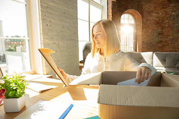 Image showing A young businesswoman moving in office, getting new work place