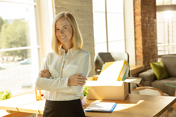 Image showing A young businesswoman moving in office, getting new work place