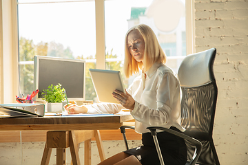 Image showing A young businesswoman moving in office, getting new work place