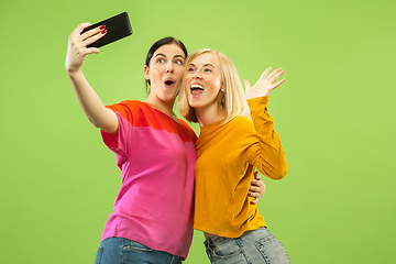 Image showing Portrait of pretty girls isolated on green studio background