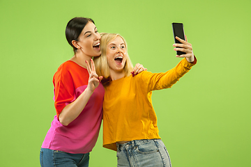 Image showing Portrait of pretty girls isolated on green studio background