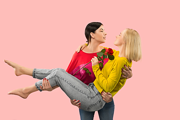 Image showing Pretty female couple on romantic coral background