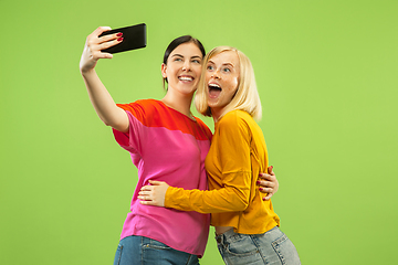 Image showing Portrait of pretty girls isolated on green studio background