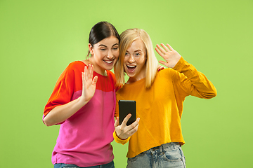 Image showing Portrait of pretty girls isolated on green studio background