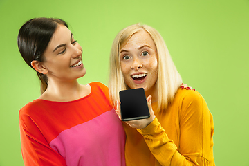 Image showing Portrait of pretty girls isolated on green studio background