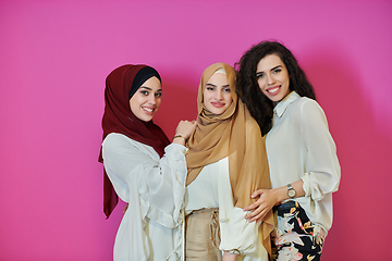 Image showing Young muslim women posing on pink background
