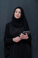 Image showing Young Arab businesswoman in traditional clothes or abaya with tablet computer