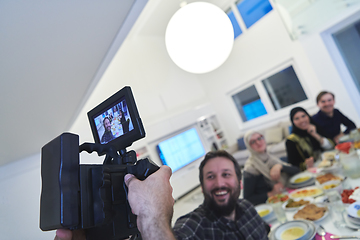 Image showing Professional videograph recording video while Muslim family having iftar together during Ramadan