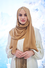 Image showing Girl wearing hijab posing on winter concept background