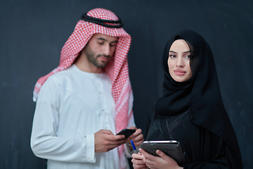Image showing Young muslim business couple using technology devices