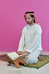 Image showing Young muslim man reading Quran during Ramadan