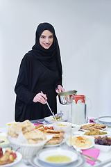 Image showing Young muslim woman serving food for iftar during Ramadan