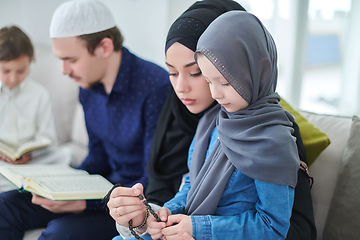 Image showing Young muslim family reading Quran during Ramadan