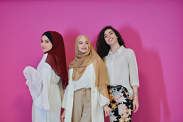 Image showing Young muslim women posing on pink background