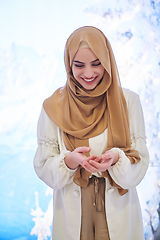 Image showing Girl wearing hijab posing on winter concept background