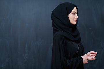 Image showing Modern young muslim woman in black abaya