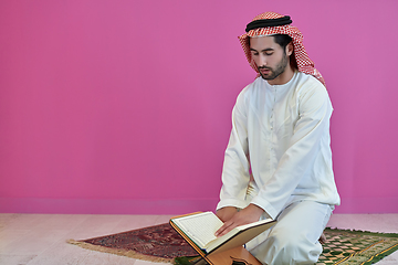 Image showing Young muslim man reading Quran during Ramadan