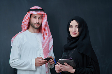 Image showing Young muslim business couple using technology devices