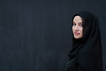 Image showing Modern young muslim woman in black abaya