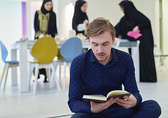 Image showing Young muslim man reading Quran during Ramadan