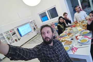 Image showing Muslim family taking selfie while having iftar together during Ramadan