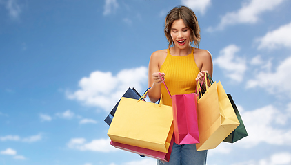 Image showing happy smiling young woman with shopping bags