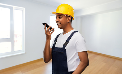 Image showing happy indian builder recording voice on smartphone