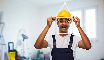 Image showing happy indian builder with ruler in shape of home