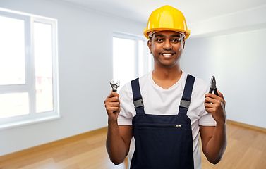 Image showing indian builder in helmet with wrench and pliers