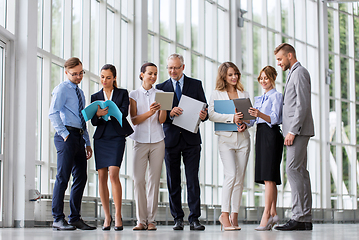 Image showing business team with tablet pc and folders at office