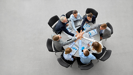 Image showing happy business people stacking hands