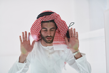 Image showing Muslim man doing sujud or sajdah on the glass floor