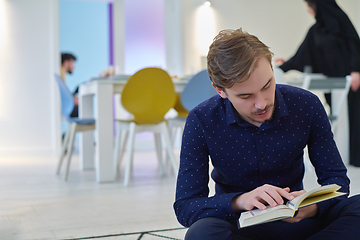 Image showing Young muslim man reading Quran during Ramadan