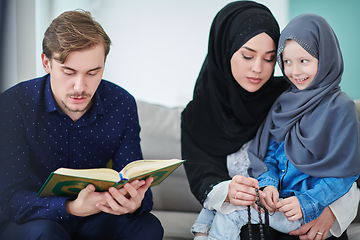 Image showing Young muslim family reading Quran during Ramadan