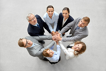 Image showing happy business people stacking hands