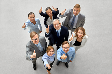 Image showing happy smiling business people showing thumbs up