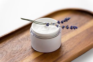 Image showing close up of lavender moisturizer on wooden tray