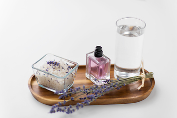 Image showing sea salt, perfume and lavender on wooden tray