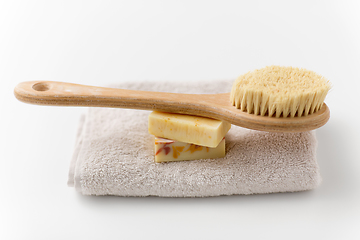 Image showing crafted soap bars, natural brush and bath towel